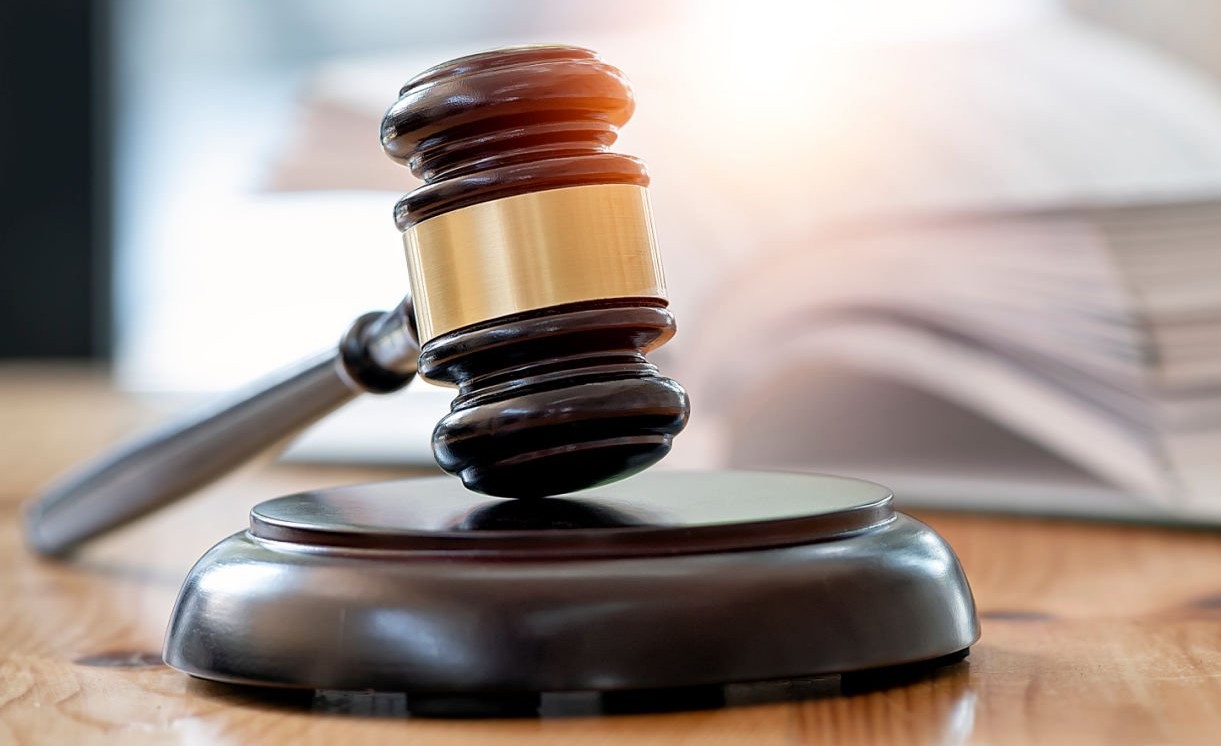 Wooden brown judge gavel on the table, copy space, banner background.